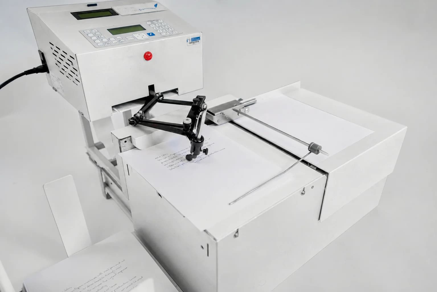 Universal Plus pen arm writing a handwritten letter